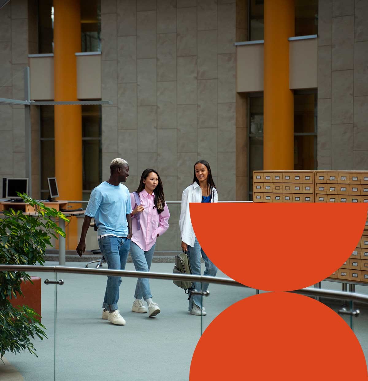 Students walking across a campus atrium